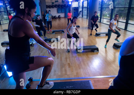 senior citizens participating in a low-impact chair aerobics class