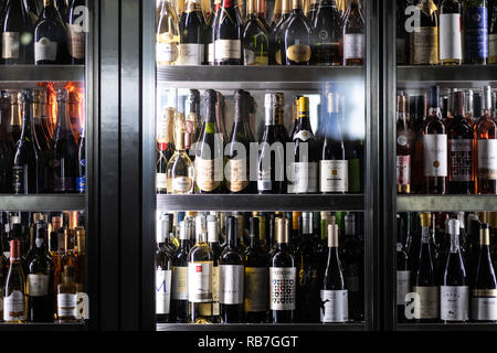 Wine bottles in large cooler fridge at a restaurant Stock Photo