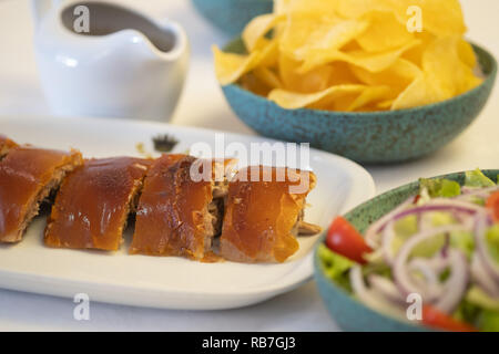 Leitão assado - traditional Portugal Bairrada region roasted piglet with french fries, salad and orange Stock Photo