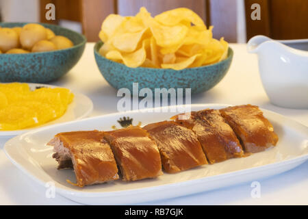 Leitão assado - traditional Portugal Bairrada region roasted piglet with french fries, salad and orange Stock Photo