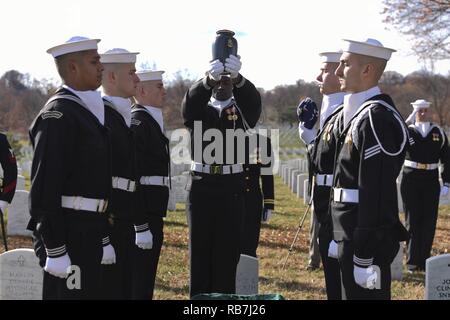 ARLINGTON, Va. (Dec. 5, 2016) Petty Officer 2nd Class Andrew Johnson, assigned to the U.S. Navy Ceremonial Guard, lowers the cremains of prior Master Chief Petty Officer of the Navy (MCPON) William “Bill” H. Plackett during an interment ceremony at Arlington National Cemetery. Plackett, who became the Navy’s sixth MCPON on Oct. 1, 1985, died March 4, 2016, at the age of 78. Stock Photo