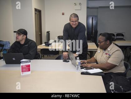 NORFOLK, Va. (Dec. 6, 2016) Retired Capt. John Malfitano, program manager of Onward to Opportunity (O2O), center, conducts an O2O orientation session with a group of service members. O2O is a program created to train and connect transitioning service members and their spouses with hiring employers. The first iteration of O2O in the Hampton Roads area is scheduled to begin Jan. 17 on Naval Station Norfolk. Stock Photo