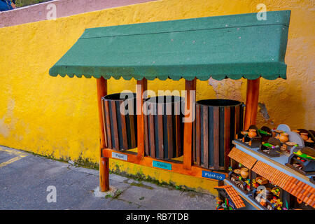 CUICOCHA, ECUADOR, NOVEMBER 06, 2018: Outdoor view of handycrafts close to a garbage collector in a paper, glass and plastic collector in the Cuicocha lake Stock Photo
