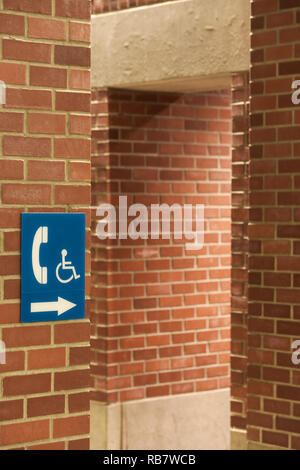 Handicapped person's informative sign on a red brick wall Stock Photo