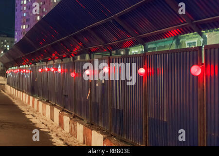 Wall on a construction site with red light bulbs Stock Photo