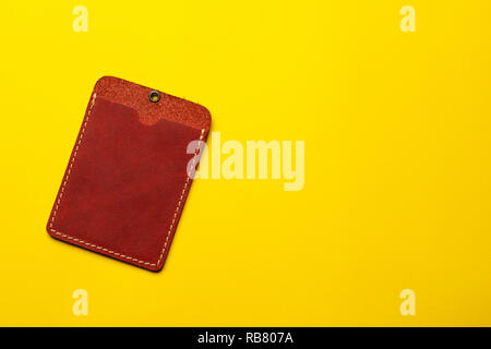 Red leather card holder mock up on yellow background. Sleeve cardholder pocket. Flat lay background. Business concept. Stock Photo