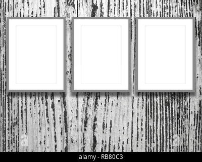 Three blank gray picture frames on scratched wooden background Stock Photo