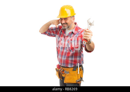 Friendly constructor making phone gesture as call me concept while holding wrench isolated on white Stock Photo