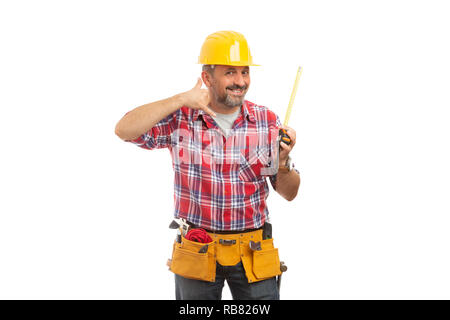 Smiling trustworthy builder making phone gesture with fingers holding measuring tape isolated on white background Stock Photo