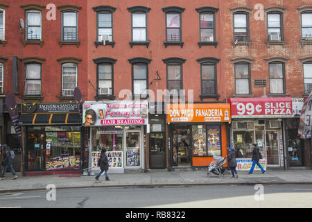 Storefronts along 3rd Avenue in East Harlem also known as Spanish Harlem and El Barrio above 96th Street in Manhattan, New York City. Stock Photo