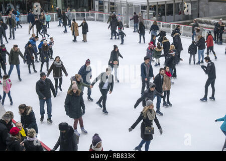 People ice skating during the Christmas Holiday season at Rockefeller Center in midtown Manhattan, New York City. Stock Photo