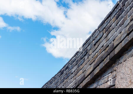 Sky clouds over stone fence Stock Photo