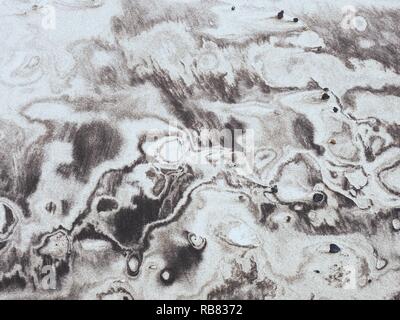 Sediments in wet sand created natural kind of picture.  Swirls with a soft, smooth and sandy texture. Stock Photo