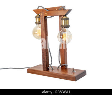 Rustic wood table lamp with small white lampshade isolated on white background Stock Photo