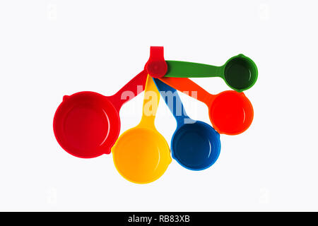 Color plastic dosing spoons isolated on a white background. Stock Photo