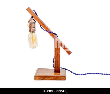 Rustic wood table lamp with small white lampshade isolated on white background Stock Photo