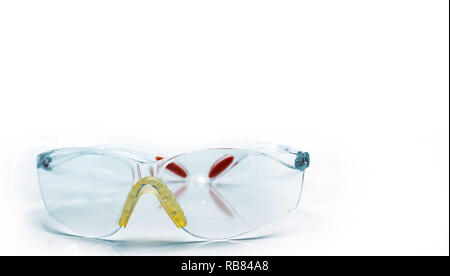 Plastic safety glasses isolated on white background. Goggles for protective eye of worker at construction site or in factory. Safety and security tool Stock Photo