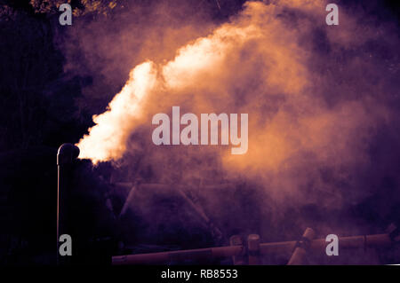 Hot steam flowing out from pipe Stock Photo