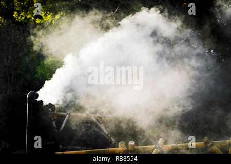 Hot steam flowing out from pipe Stock Photo