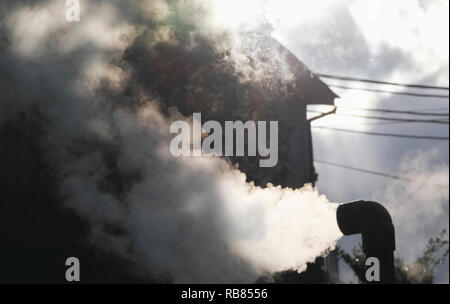 Hot steam flowing out from pipe Stock Photo