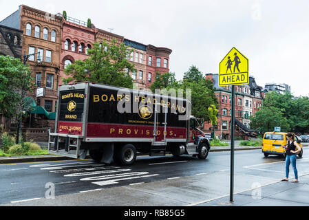 New York City, USA - July 25, 2018: Truck on Malcolm X Boulevard with people around in Harlem, Manhattan, New York City, USA Stock Photo