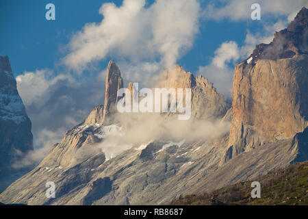 Clouds surround the the mountains of Torres del Paine before sunrset. Chile Stock Photo