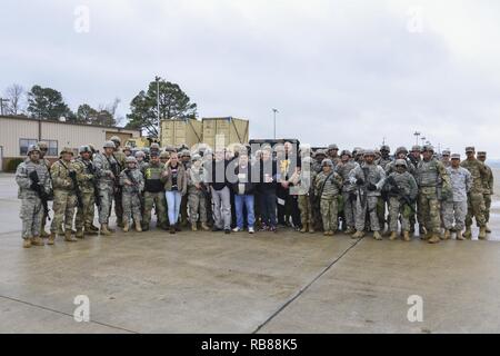 UFC fighters Ben Rothwell, Valentina Shevchenko, and Lorenz Larkin pose for a photo with U.S. Army Soldiers from the 7th Transportation Brigade (Expeditionary) at Joint Base Langley-Eustis, Va., Dec. 8, 2016. The fighters met with the Soldiers to discuss their daily operations and to thank them for their dedication. Stock Photo