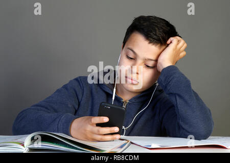 12-year-old schoolboy using a cell phone. Paris, France. Stock Photo