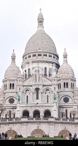 PARIS, FRANCE - JANUARY 05: Sacre Coeur Basilica in Paris on JANUARY 05, 2010. Tourists in Front of Basilica of the Sacred Heart of Jesus at Montmartr Stock Photo