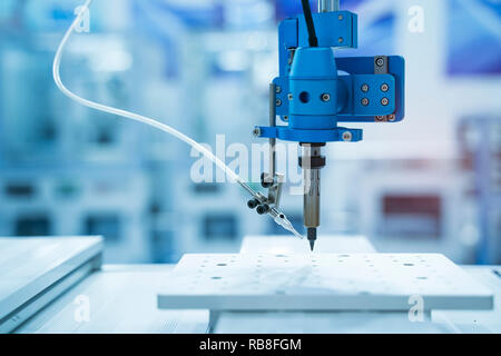 soldering iron tips of robotic system for automatic point soldering for printed and assembly electric circuit board ( PCB ) at factory Stock Photo