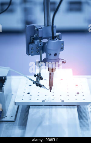 soldering iron tips of robotic system for automatic point soldering for printed and assembly electric circuit board ( PCB ) at factory Stock Photo