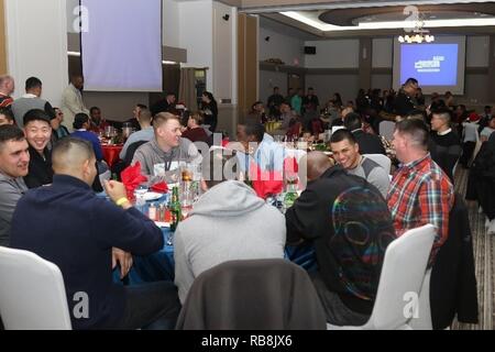 Camp Casey, South Korea -- Soldiers from 70th Brigade Support Battalion enjoy a banquet during the 70th BSB Holiday Party, December 15, at the Warriors Club on Camp Casey. The party offered the Soldiers an opportunity to get to know each other and raise the unit cohesion. Stock Photo