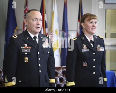 Army Reserve Brig. Gen. Christopher R. Kemp (Retired)(Left), former commander of the 335th Signal Command (Theater), and Army Reserve Brig. Gen. Nikki Griffin-Olive, deputy commander of sustainment, 335th SC (T) sing the Army Song during her promotion ceremony at the Clay Army National Guard Center, Marietta, Georgia, Dec. 16.  Olive, a native of Spokane, Washington, has held numerous leadership positions throughout her career including her recent command of the 359th Theater Tactical Signal Brigade, 335th SC (T). Stock Photo