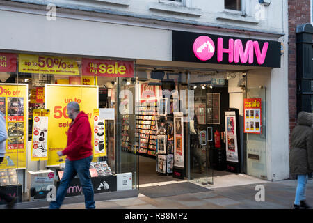 Pedestrian walking past HMV, Worcester, England, one of the last chain stores selling physical music Stock Photo