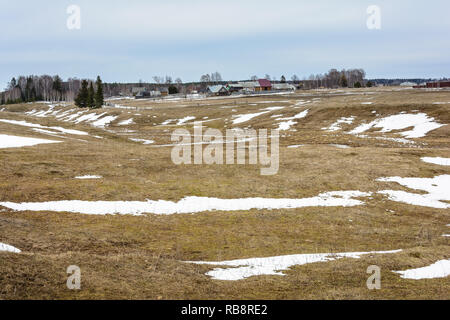 The melting of the snow on the fields in early spring Stock Photo