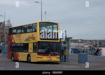 First Wessex, slow-coaster bus loading passengers in Weymouth, a sea-side town Stock Photo