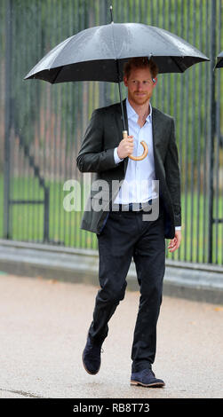 Prince Harry arrives to view tributes attached to the Golden Gates of Kensington Palace, left to his late mother Diana, Princess of Wales. Stock Photo