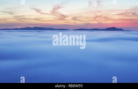 Dramatic clouds with mountain silhouette in dawn, Slovakia. Stock Photo