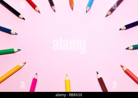 Seamless colored rainbow pencils lined around the contour, on pink background isolated. Concept of free space, copyspace, cover of notebook, album for Stock Photo