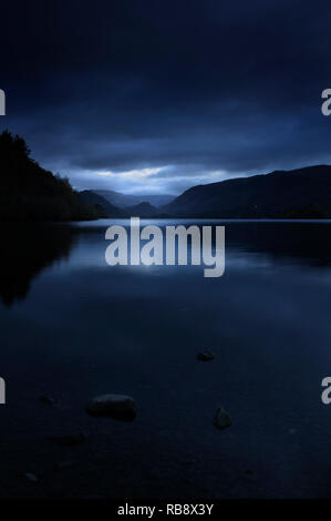 A dark atmospheric lakeland scene looking across Derwentwater towards Borrowdale, Lake District, Cumbria, England, UK Stock Photo