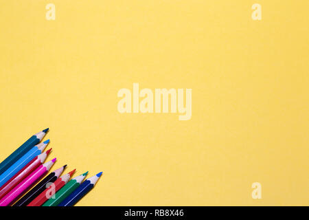 Seamless colored rainbow pencils lined around the contour, on pink background isolated. Concept of free space, copyspace, cover of notebook, album for Stock Photo