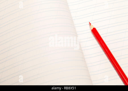 Closeup notebook and red pencil with blank lined sheets white paper. Concept clear free space, copyspace, business book, diary, notepad, notes at prof Stock Photo