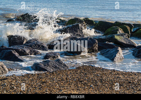 Surf breaking over rocks Clacton on Sea Essex England UK Stock Photo