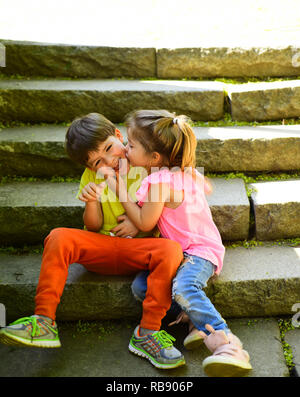 best friends, friendship and family values. couple of little children. Boy and girl. summer holiday vacation. childhood first love. small girl and boy. Relations. Small romantic kids on stairs. Stock Photo