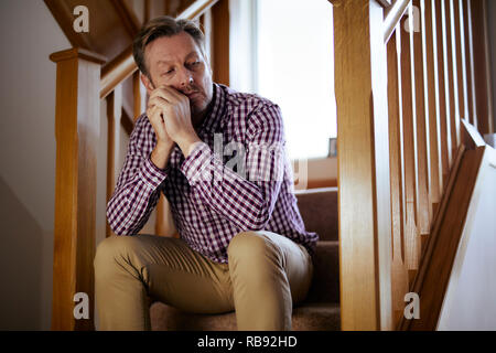 Man sat on stairs thoughtful Stock Photo