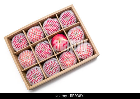red apples with shockproof foam net wrap in paper box isolated on white background Stock Photo