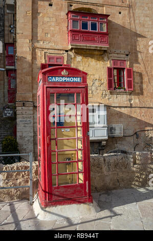 Red telephone box in valletta, Malta. Stock Photo