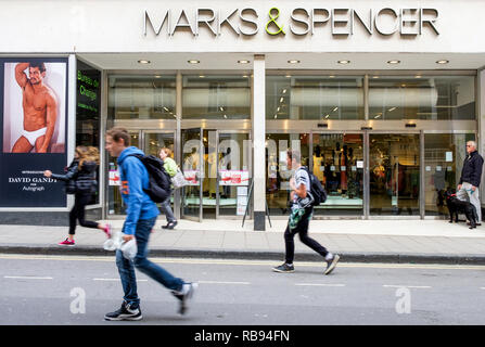 High street shoppers are pictured walking past a Marks & Spencer department store shop in Bath,England, UK Stock Photo