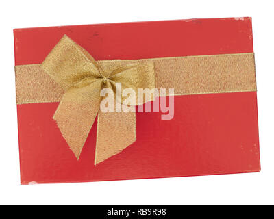 Old red Christmas or Valentine gift box with gold ribbon bow, isolated on white background. Last year's romance. Top view. Stock Photo