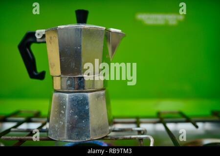 Heating up espresso coffee in a Cuban coffee maker using a mini gas stove  with a Coleman propane tank on a single burner. A thunderstorm is  approaching Stock Photo - Alamy